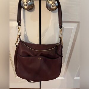 Vera Bradley leather/Suede crossbody/Shoulder Bag.Looks like a cranberry color.